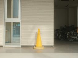 a yellow cone sitting in front of a building